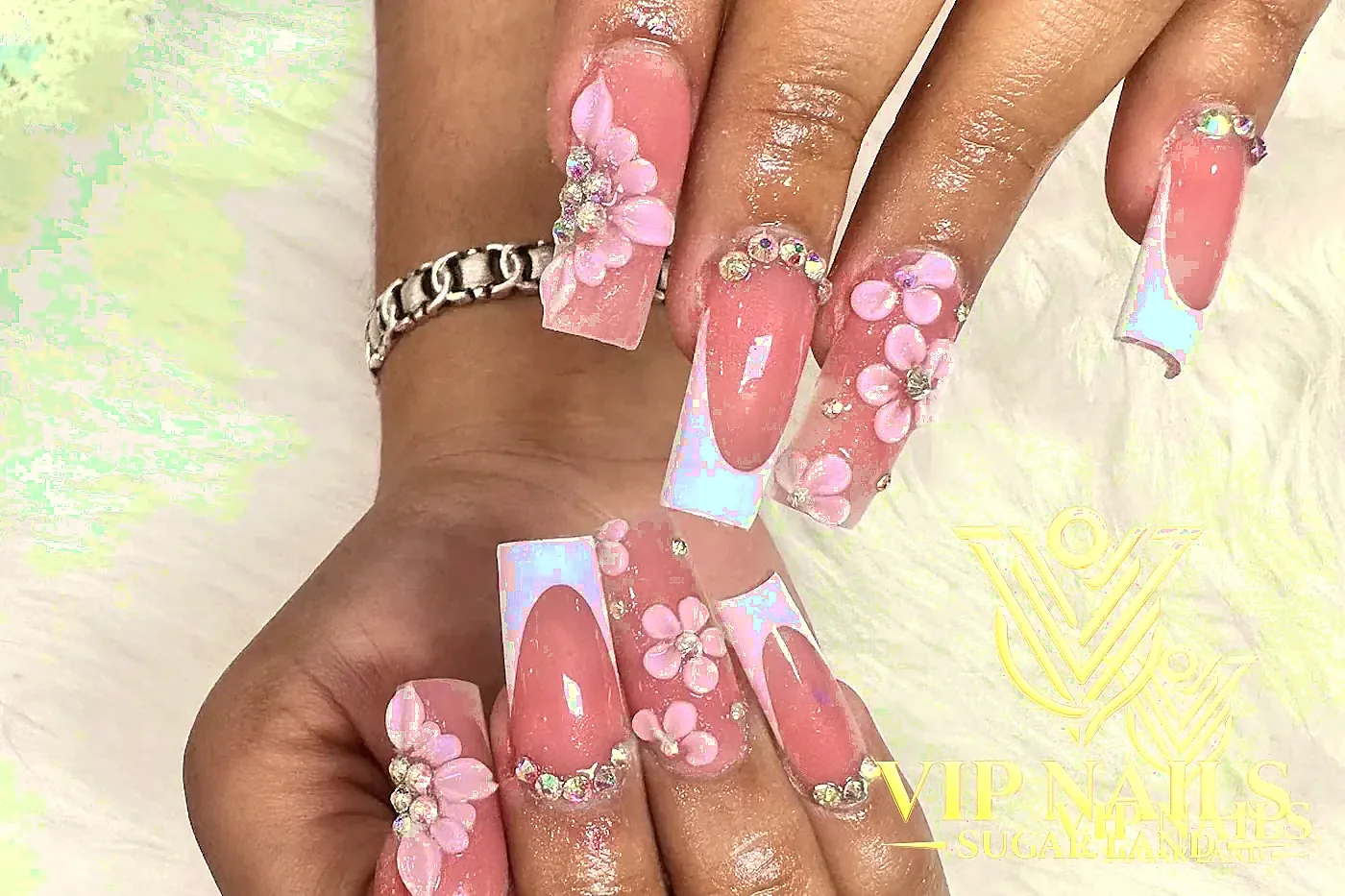XL French tip nails with sculpted 3D white florals and crystals
