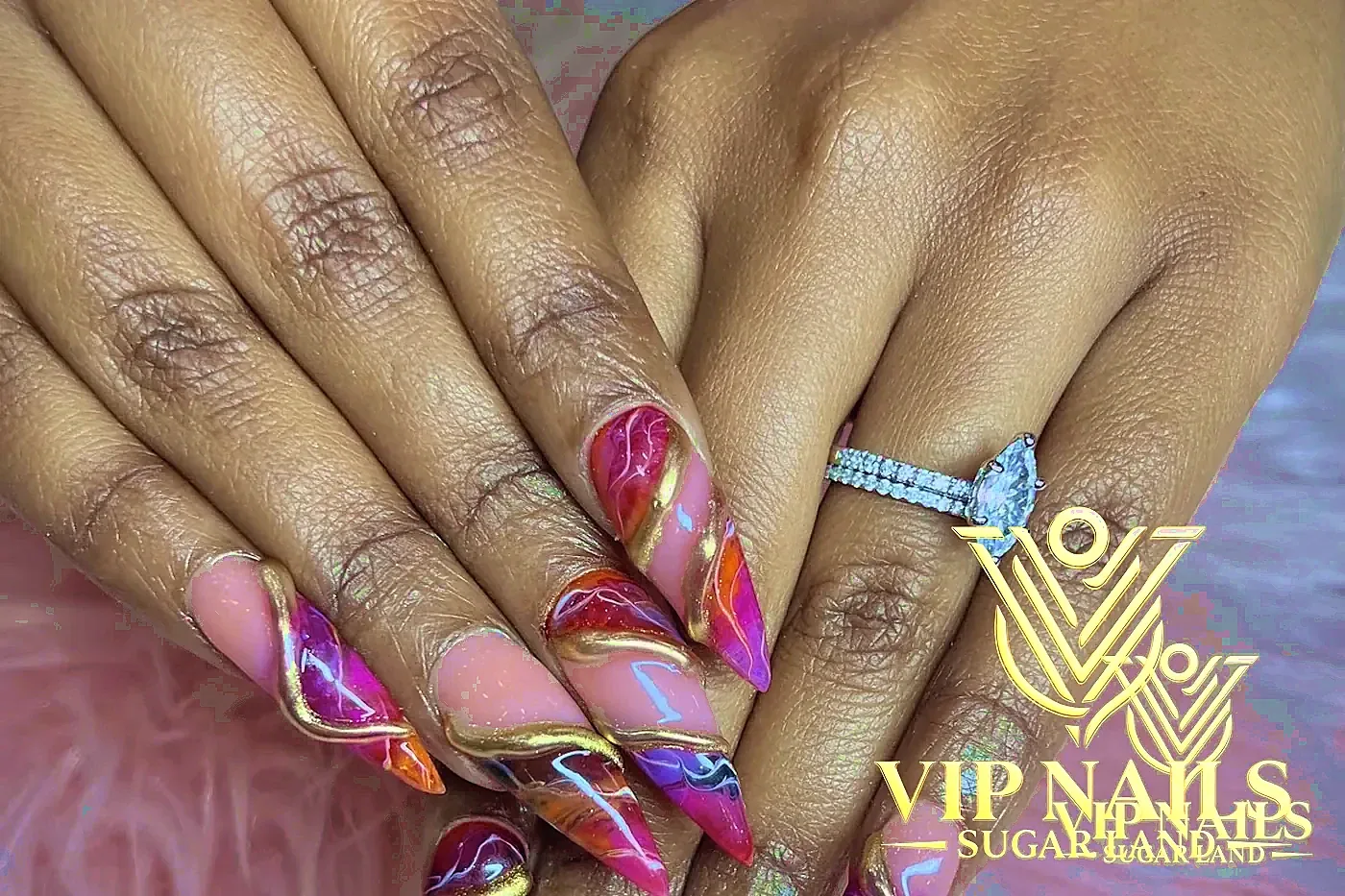 XL stiletto nails with magenta marble and raised gold chrome lines