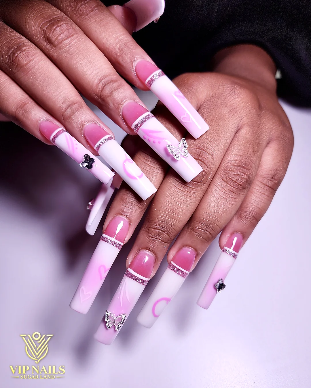 Long pink coffin acrylic set with Barbie-inspired art and gems by VIP Nails Sugar Land