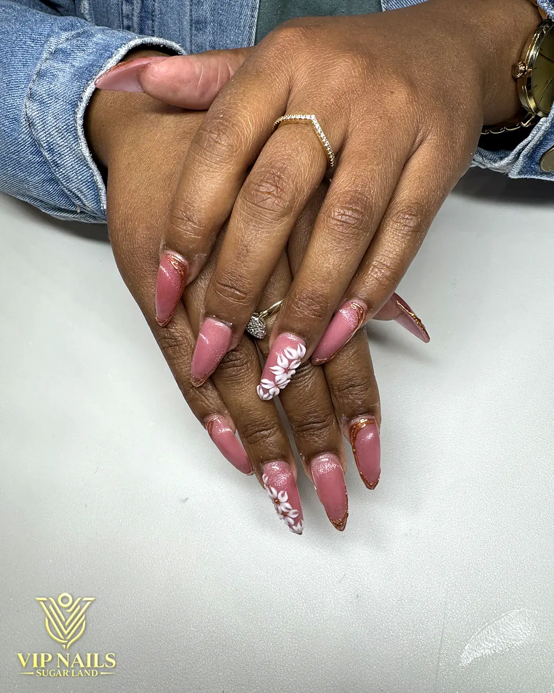 Mauve almond nails with hand-painted floral art by VIP Nails Sugar Land