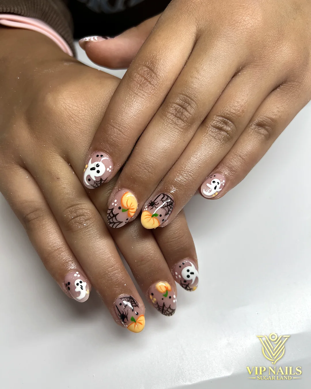 Short round nails with hand-painted Halloween characters by VIP Nails Sugar Land