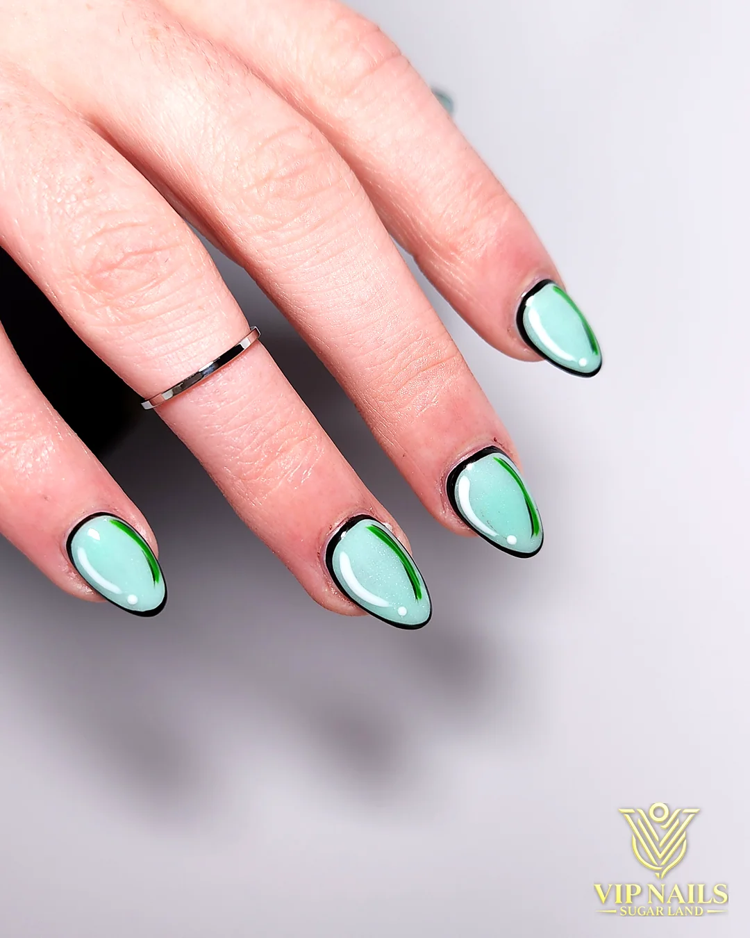 Mint nails with hand-drawn black outline art by VIP Nails Sugar Land