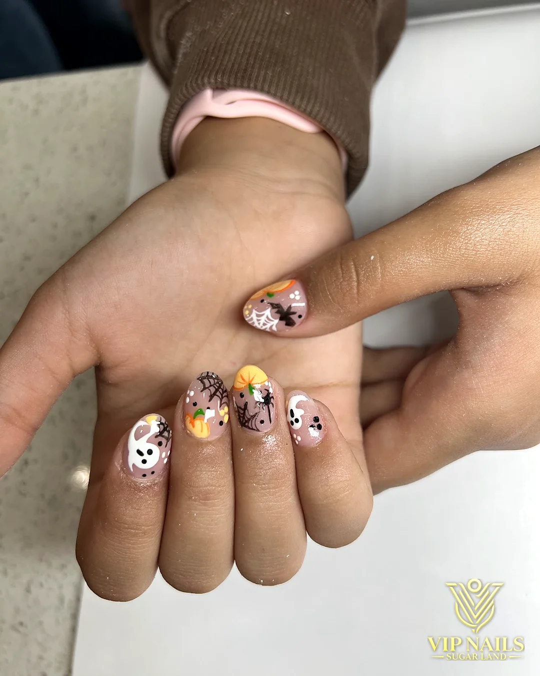 Short nails with hand-painted pastel flower art by VIP Nails Sugar Land