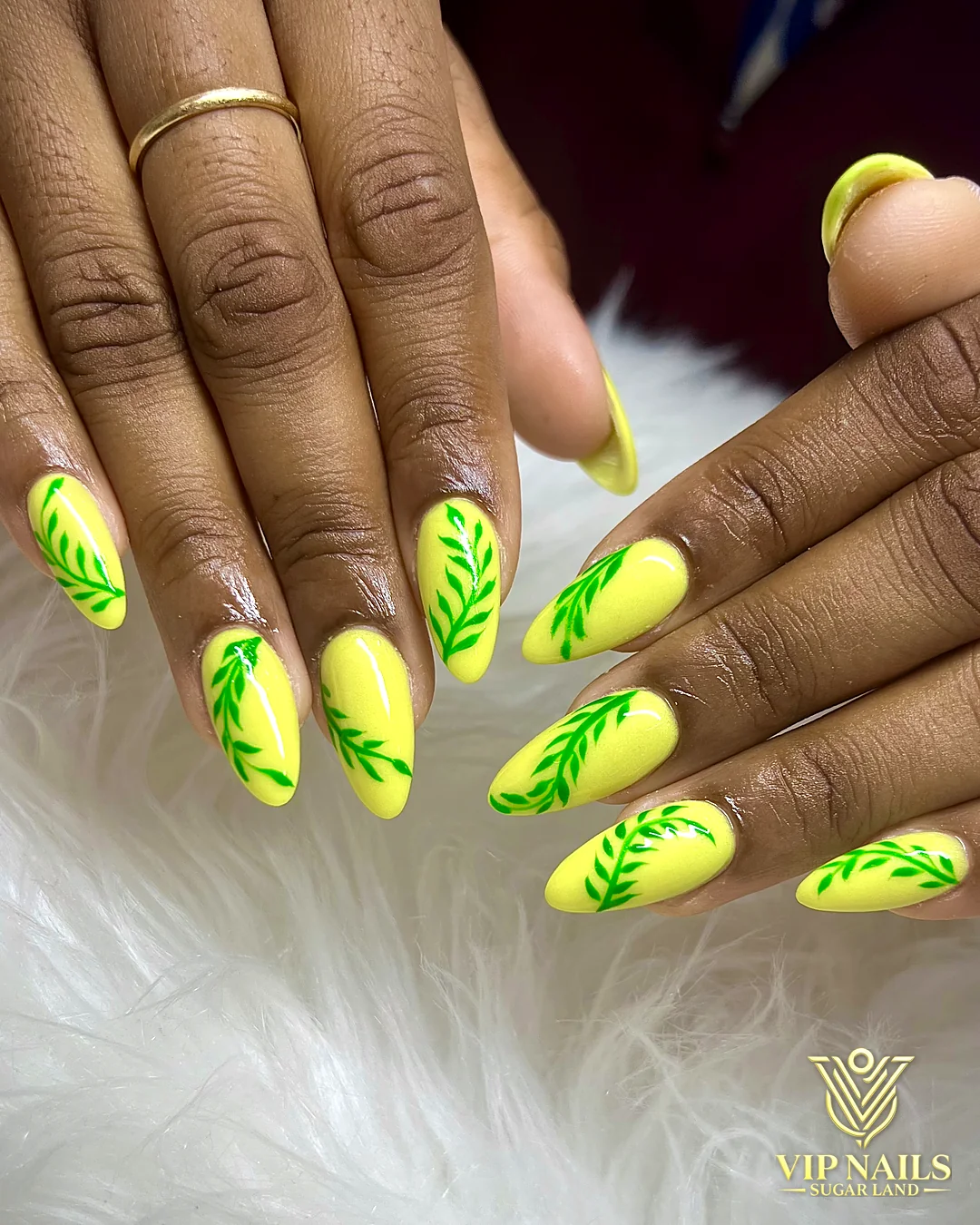 Neon yellow almond set with painted leaves by VIP Nails Sugar Land